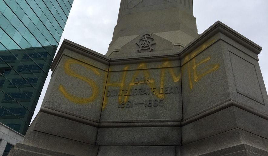 A word "SHAME" is is spray-painted on the Confederate monument located downtown on East Main Street in Norfolk, Va., on Monday, May 22, 2017. The Norfolk City Council decided in 2015 to keep the monument, despite pressure from a local civil rights group. (Lee Tolliver /The Virginian-Pilot via AP)