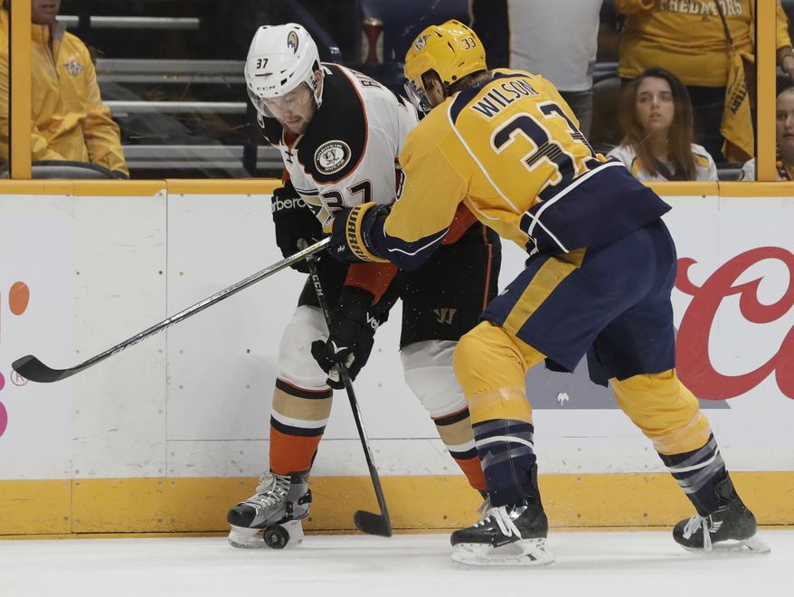 Anaheim Ducks left wing Nick Ritchie (37) is checked against the boards by Nashville Predators left wing Colin Wilson (33) during the first period in Game 6 of the Western Conference final in the NHL hockey Stanley Cup playoffs Monday, May 22, 2017, in Nashville, Tenn. (AP Photo/Mark Humphrey)