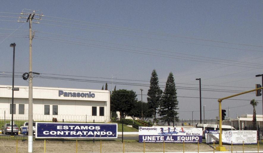 This April 28, 2017 photo shows a sign that says &amp;quot;We&#x27;re hiring&amp;quot; outside a Panasonic &amp;quot;maquiladora&amp;quot; in an industrial park in Reynosa, Mexico, across the border from McAllen, Texas. A long-time factory worker said he worried that if maquila jobs decrease, the unemployed would fill the ranks of a drug cartels that control Mexican border towns. (AP Photo/Christopher Sherman)