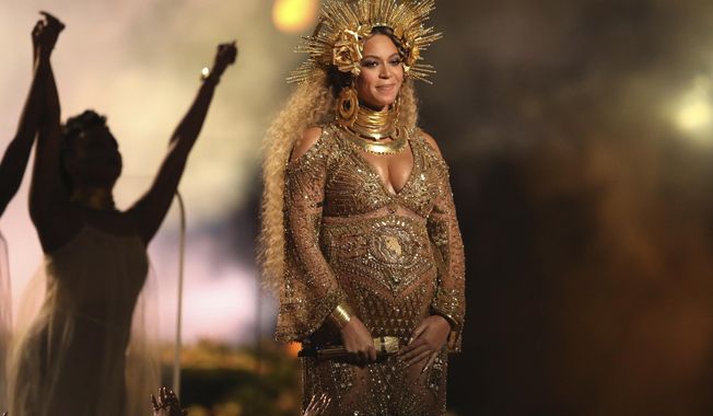 FILE - This Feb. 12, 2017, file photo shows Beyonce performing at the 59th annual Grammy Awards in Los Angeles. Beyonce and Jay Z celebrated the impending birth of their twins with a “push party” on May 20, 2017. (Photo by Matt Sayles/Invision/AP, File)