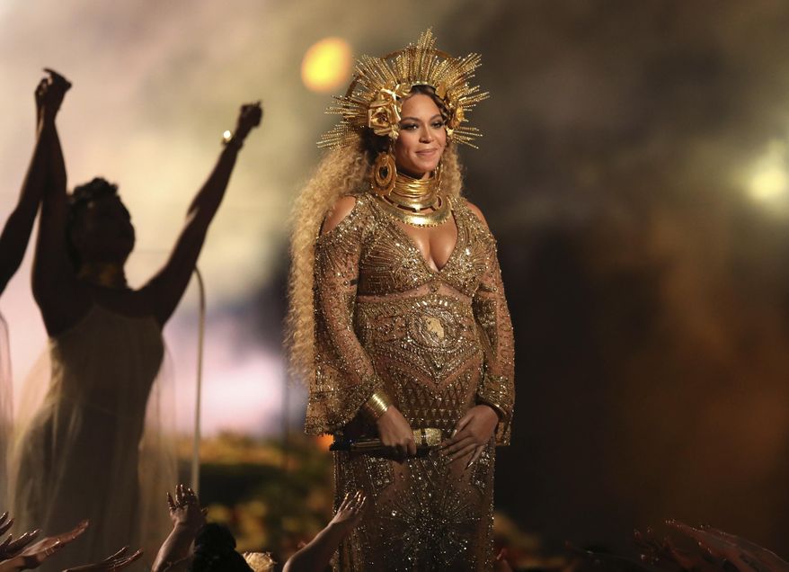 FILE - This Feb. 12, 2017, file photo shows Beyonce performing at the 59th annual Grammy Awards in Los Angeles. Beyonce and Jay Z celebrated the impending birth of their twins with a “push party” on May 20, 2017. (Photo by Matt Sayles/Invision/AP, File)