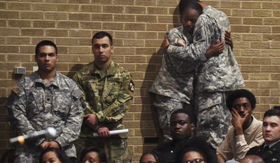 Bowie State University ROTC students comfort each other during a memorial vigil for Richard Collins III, who was killed Saturday at the University of Maryland in College Park, as they gather at Bowie State&#39;s auditorium in Bowie, Md., Monday, May 22, 2017. Authorities appealed for patience Monday from two college communities reacting in shock, fear and anger after a white University of Maryland student was arrested in what police called the unprovoked stabbing of a black Bowie State University student. (Kenneth K. Lam/The Baltimore Sun via AP)