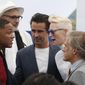 Actors Will Smith, left, Collin Farrell, Christopher Waltz talk after actors and directors from former Cannes selections posed for photographers during the photo call for the 70th Anniversary of the international film festival, Cannes, southern France, Tuesday, May 23, 2017. (AP Photo/Thibault Camus)
