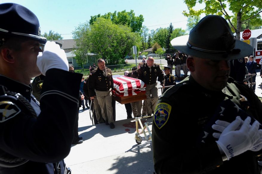 The casket carrying slain Broadwater County Deputy Mason Moore is carried into Three Forks High School, in Three Forks, Mont., Tuesday, May 23, 2017. Moore was shot and killed in the line of duty early on May 16, near Three Forks. (Thom Bridge/Independent Record via AP)
