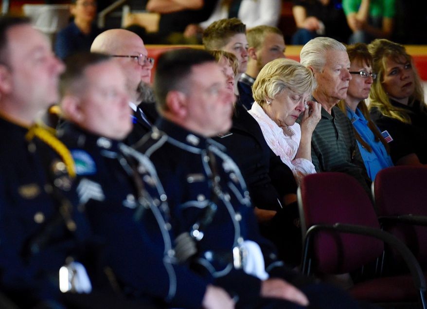 Guests watch a live stream of Broadwater County Deputy Mason Moore's memorial service Tuesday, May 23, 2017, in the gym at Three Forks High School, one of two sites were the memorial was live streamed. Moore was shot and killed in the line of duty early on May 16, near Three Forks. (Thom Bridge/Independent Record via AP)