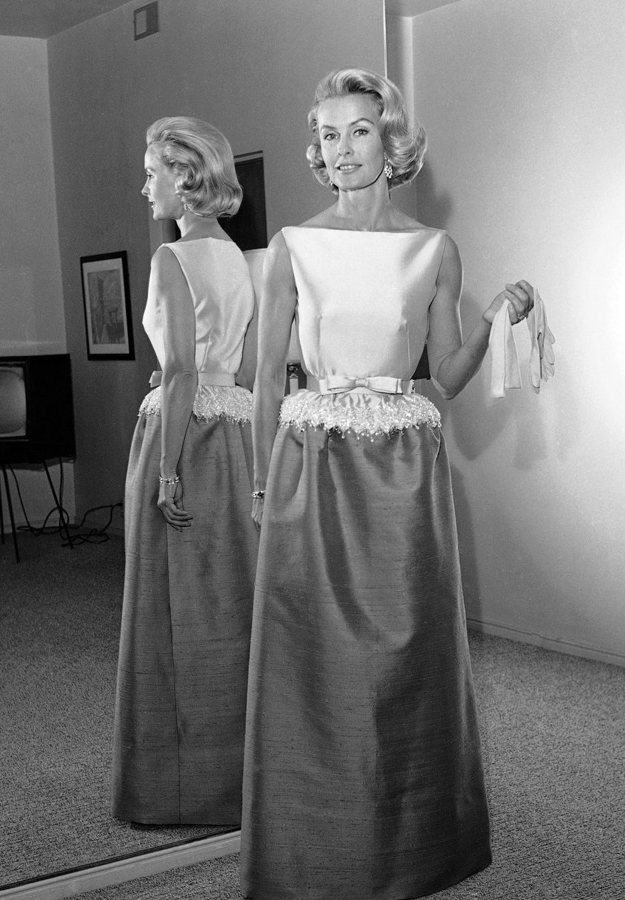 FILE - In this April 6, 1962 file photo, socialite-actress Dina Merrill models the gown she will wear at the Academy Awards presentation in Los Angeles. Merrill, the rebellious heiress who defied her super-rich parents to become an actress, died Monday, May 22, 2017, at age 93. (AP Photo/Harold P. Matosian, File)
