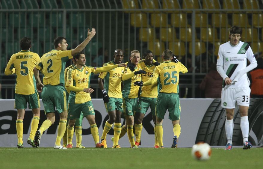 FILE - In this Thursday, Nov. 28, 2013 file photo Kuban's players celebrate after scoring against St. Gallen during their Europa League Group A soccer match in Krasnodar, Russia. Kuban Krasnodar's fans hoped signing Andrei Arshavin would herald long-awaited success for their club. The local governor hoped for a pre-election boost. (AP Photo/Vitaly Timkiv, File)