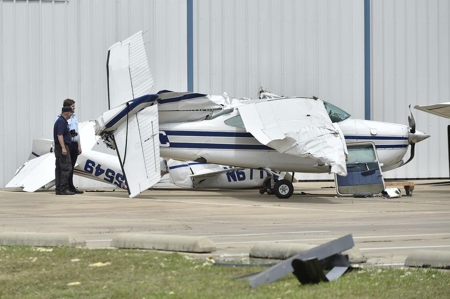 A small plane sustained damage during an overnight storm at Denton Enterprise Airport, Tuesday, May 23, 2017, in Denton, Texas. Authorities say more than a dozen small planes have been damaged as storms packing strong winds struck the North Texas airport. (Jeff Woo/The Denton Record-Chronicle via AP)