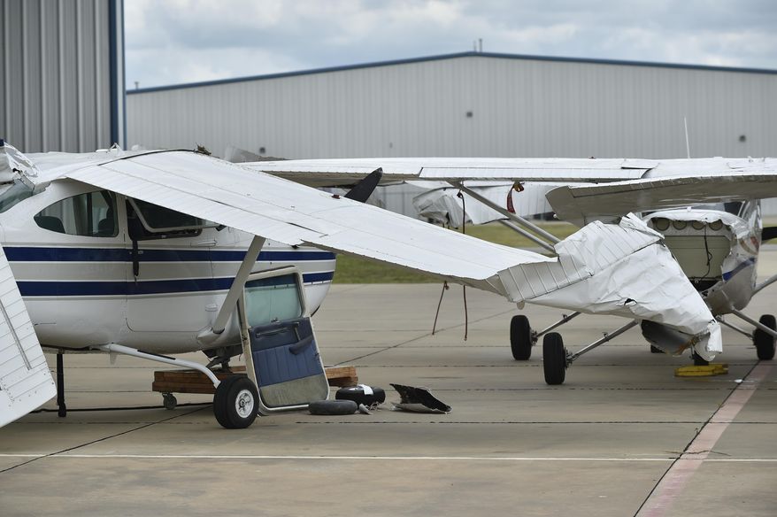 A small plane sustained damage during an overnight storm at Denton Enterprise Airport, Tuesday, May 23, 2017, in Denton, Texas. Authorities say more than a dozen small planes have been damaged as storms packing strong winds struck the North Texas airport. (Jeff Woo/The Denton Record-Chronicle via AP)