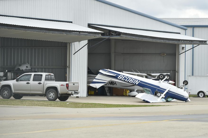 A small plane sustained damage during an overnight storm at Denton Enterprise Airport, Tuesday, May 23, 2017, in Denton, Texas. Authorities say more than a dozen small planes have been damaged as storms packing strong winds struck the North Texas airport. (Jeff Woo/The Denton Record-Chronicle via AP)