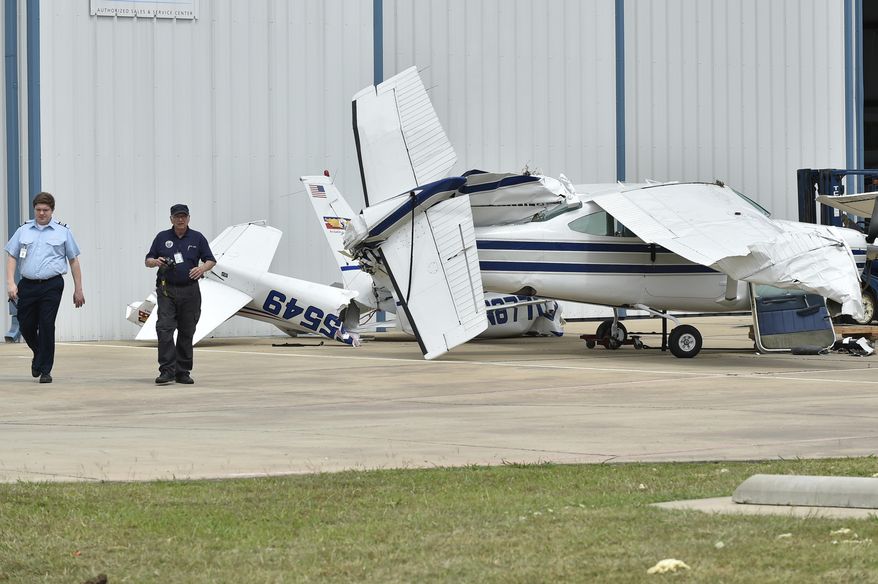 A small plane sustained damage during an overnight storm at Denton Enterprise Airport, Tuesday, May 23, 2017, in Denton, Texas. Authorities say more than a dozen small planes have been damaged as storms packing strong winds struck the North Texas airport. (Jeff Woo/The Denton Record-Chronicle via AP)