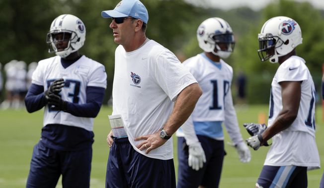Tennessee Titans head coach Mike Mularkey watches as players run drills during the team's organized team activity at its NFL football training facility Tuesday, May 23, 2017, in Nashville, Tenn. (AP Photo/Mark Humphrey)