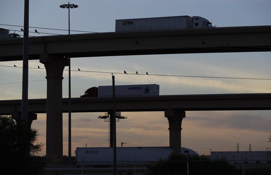 FILE - In this Nov. 21, 2016 file photo, trucks travel on an overpassed to and from the World Trade Bridge, in Laredo, Texas. Mexican and U.S. customs authorities have closed this commercial crossing, the border’s busiest, after damaging rains and winds on Sunday, May 21, 2017, according to U.S. Customs and Border Protection. (AP Photo/Eric Gay, File)