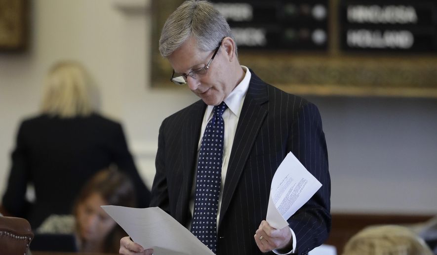 Texas Rep. Phil King, R-Weatherford, looks over papers before debate over SB5, a weakened version of the state's voter ID law that a federal judge called discriminatory, Tuesday, May 23, 2017, in Austin. (AP Photo/Eric Gay)