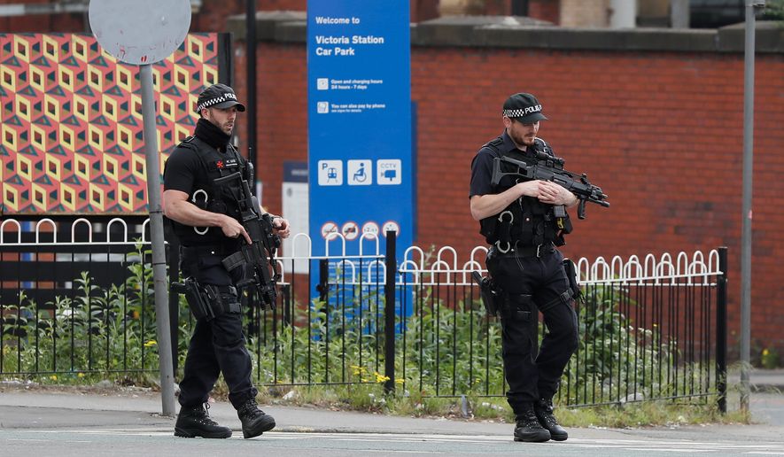 Britons will find armed troops at vital locations Wednesday after the official threat level was raised to its highest point following a suicide bombing on Monday that killed 22. (Associated Press)