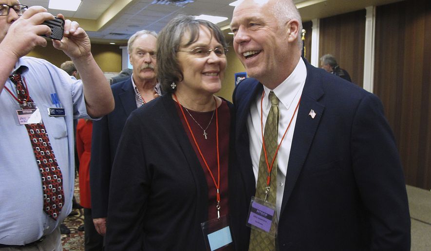 FILE - In this March 6, 2017, file photo, Greg Gianforte, right, receives congratulations from a supporter in Helena, Mont. Montana voters are heading to the polls Thursday, May 25, 2017, to decide a nationally watched congressional election amid uncertainty in Washington over President Donald Trump&#39;s agenda and his handling of the country&#39;s affairs. (AP Photo/Matt Volz, File)