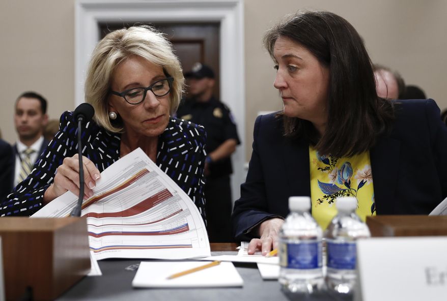 Education Secretary Betsy DeVos, left, accompanied by Education Department Budget Service Director Erica Navarro, looks over her notes on Capitol Hill in Washington, Wednesday, May 24, 2017, as they testified before the House Appropriations Labor, Health and Human Services, Education, and Related Agencies subcommittee hearing on the Education Department's fiscal 2018 budget. (AP Photo/Carolyn Kaster)