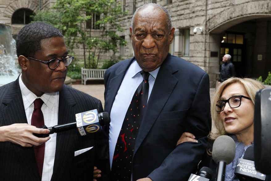 Bill Cosby, center, pauses in the courtyard as one of his attorneys Angela Agrusa, right, makes a statement to the media, as they arrive for the third day of jury selection in his sexual assault case at the Allegheny County Courthouse, Wednesday, May 24, 2017, in Pittsburgh. The case is set for trial June 5 in suburban Philadelphia. (AP Photo/Gene J. Puskar)