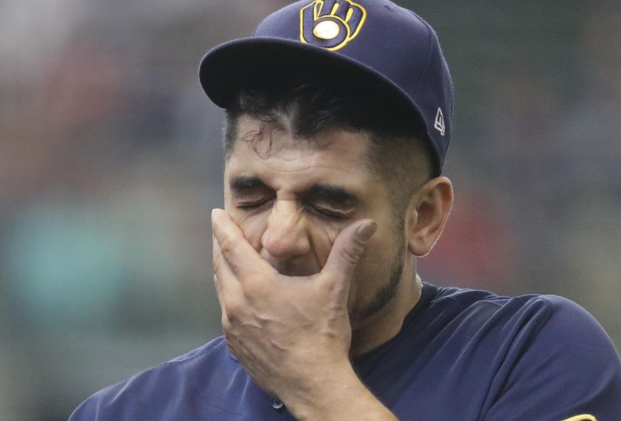 Milwaukee Brewers starting pitcher Matt Garza wipes his face after being taken out of the game during the sixth inning of a baseball game against the Toronto Blue Jays Wednesday, May 24, 2017, in Milwaukee. (AP Photo/Morry Gash)