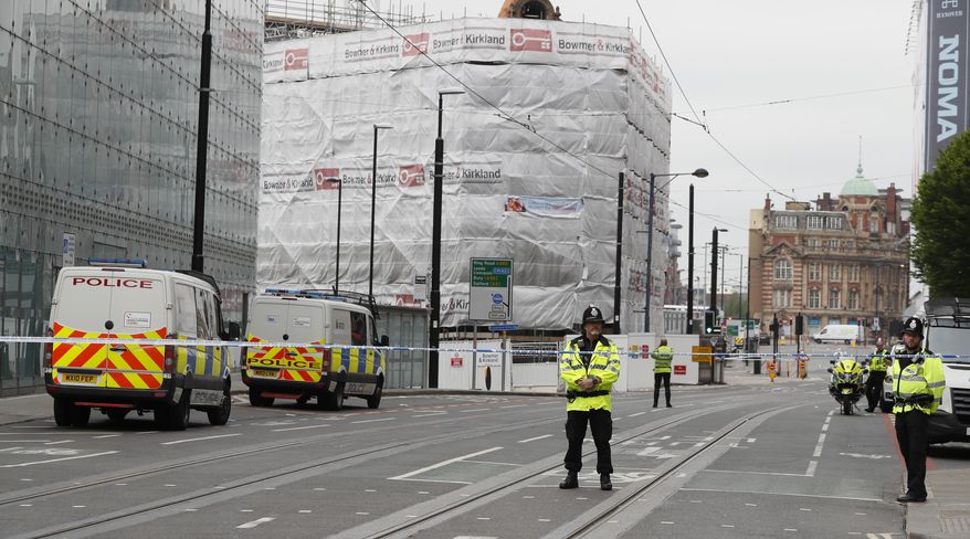 Police keep guard on a cordoned area in Manchester, England, Wednesday, May 24, 2017. Britons will find armed troops at vital locations Wednesday after the official threat level was raised to its highest point following a suicide bombing that killed 22, as new details emerged about the bomber. (AP Photo/Kirsty Wigglesworth)