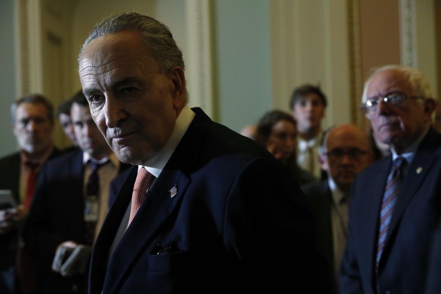Senate Minority Leader Charles Schumer of N.Y., left, accompanied by Sen. Bernie Sanders, I-Vt., right, listens to a question during a news conference on Capitol Hill in Washington, Tuesday, may 23, 2017, following a Democratic policy luncheon. (AP Photo/Jacquelyn Martin)
