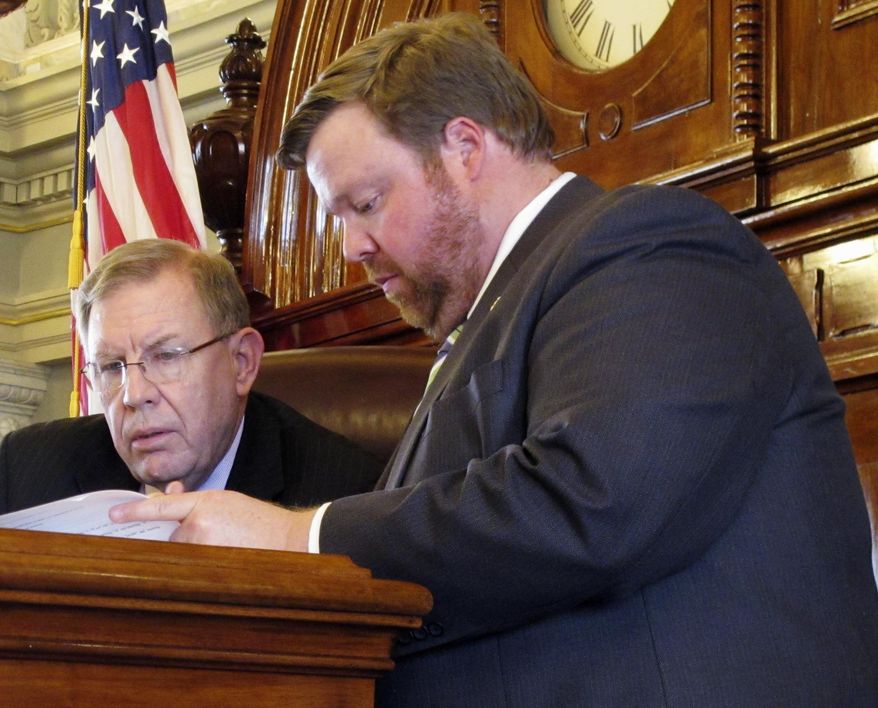 Kansas state Rep. Jim Kelly, left, R-Independence, confers with House Rules Chairman Blaine Finch, right, R-Ottawa, as Kelly presides over a debate on school funding, May 24, 2017, at the Statehouse in Topeka, Kan. The Kansas Supreme Court has said the state's education funding is inadequate, and lawmakers are looking at boosting spending. (AP Photo/John Hanna)