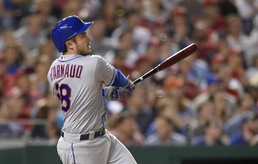 This April 28, 2017 photo shows New York Mets' Travis d'Arnaud watching his three-run home run during the fourth inning of the team's baseball game against the Washington Nationals in Washington. The Mets have activated d'Arnaud from the disabled list. After playing six games in the minors on his rehab assignment, d'Arnaud was available off the bench Wednesday, May 24, 2017 against San Diego. (AP Photo/Nick Wass)