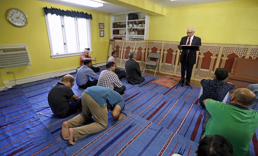 FILE – In this Friday, Sept. 23, 2016 file photo, Iftakhar Ahmad, top, a visiting religious leader from Pakistan, leads a prayer service at the Bernards Township Community Center in Basking Ridge, N.J. The Bernards Township committee voted Tuesday, May 23, 2017, to settle two lawsuits over its denial of a proposed mosque, filed by the U.S. Justice Department and the Islamic Society of Basking Ridge. Some residents say their opposition is because of the selected location, not religious intolerance. (AP Photo/Julio Cortez, File)
