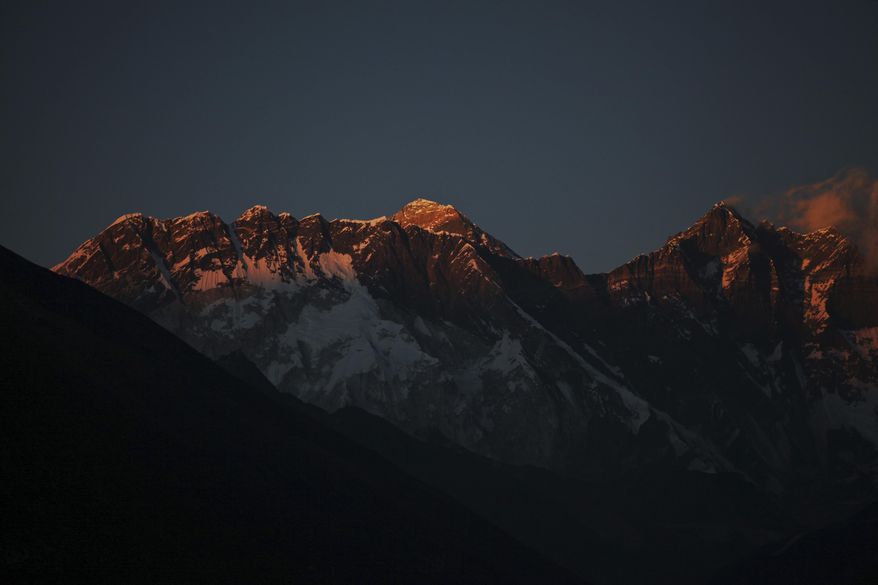 In this Feb. 18, 2016 file photo, Mount Everest, center, and Mount Lhotse, right, are seen from Tengboche, Nepal. On Tuesday May 23, 2017, sherpa rescuers have found the bodies of four climbers inside a tent on the highest camp on Mount Everest. (AP Photo/Tashi Sherpa,File)