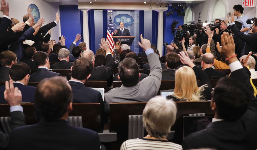 In this Feb. 22, 2017, file photo, reporters raise their hands as White House press secretary Sean Spicer takes questions during the daily briefing in the Brady Press Briefing Room of the White House in Washington. On June 30, 2017, the White House Correspondent Association awarded Newsmax and One America News Network, two conservative cable outlets, new assigned seats in the briefing room, Politico reported.(AP Photo/Pablo Martinez Monsivais, File)