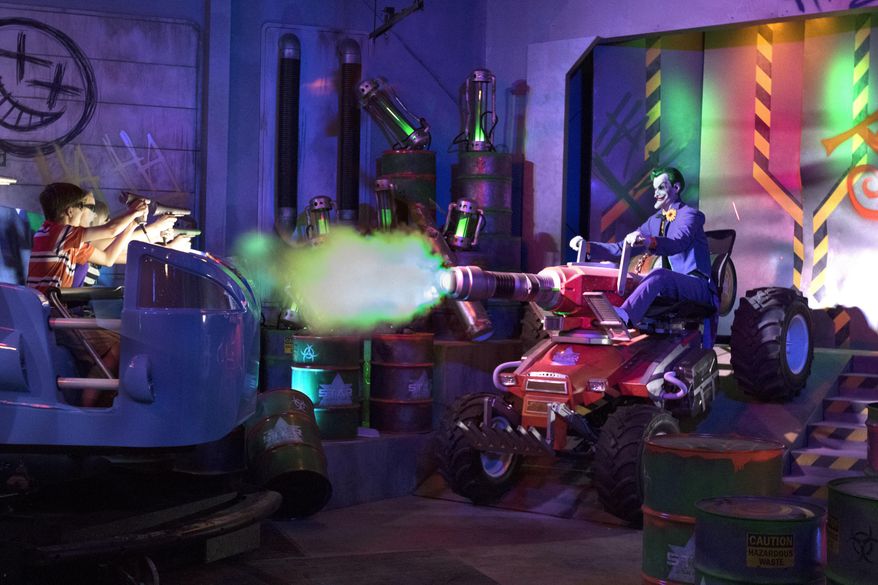 This photo provided by Six Flags Over Georgia in Austell, Georgia, shows the new "JUSTICE LEAGUE: Battle for Metropolis," a new immersive dark ride. The ride is opening at three Six Flags parks this season. In addition to Six Flags Over Georgia, it's opening at Six Flags Magic Mountain in Valencia, Calif., and Six Flags Great Adventure, in Jackson, N.J. (Six Flags Over Georgia via AP)
