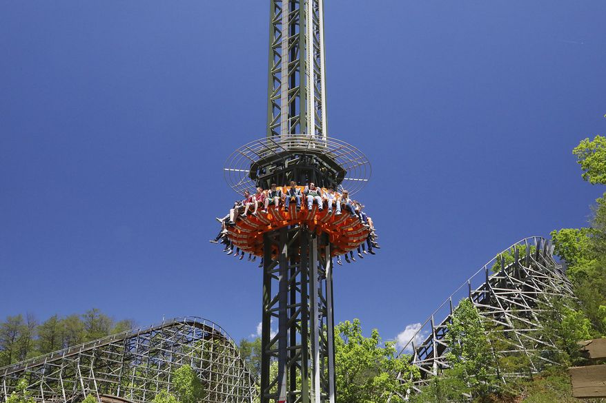 This photo provided by Dollywood in Pigeon Forge, Tenn., shows a new drop tower attraction at the Dollywood theme park. The ride's gondola spins around the tower for a bird's eye view of the Great Smoky Mountains. It's one of a number of new attractions opening at theme parks around the U.S. this spring and summer. (Curtis Hilbun/Dollywood via AP)