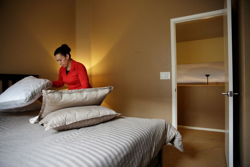 Jennifer Mesa cleans up a bedroom in the home of Randy Tussing, an Airbnb host in Las Vegas. More than 340,000 people passed on Nevada&#39;s hotel rooms last year and opted instead to book a place to stay using the short-term rental service. (Associated Press)