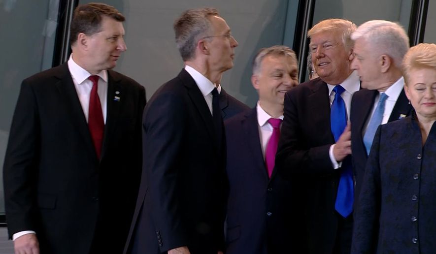 In this image taken from NATO TV, Montenegro Prime Minister Dusko Markovic, second right, appears to be pushed by US President Donald Trump as they were given a tour of NATO&#39;s new headquarters after taking part in a group photo, during a NATO summit of heads of state and government in Brussels on Thursday, May 25, 2017. (NATO TV via AP)