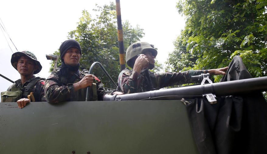 Government troops head back to the site as they battle Muslim militants who lay siege in Marawi in southern Philippines Thursday, May 25, 2017. Army tanks packed with soldiers rolled into a southern Philippine city Thursday to try to restore control after ISIS-linked militants launched a violent siege that sent thousands of people fleeing for their lives and raised fears of extremists gaining traction in the country. (AP Photo/Bullit Marquez)