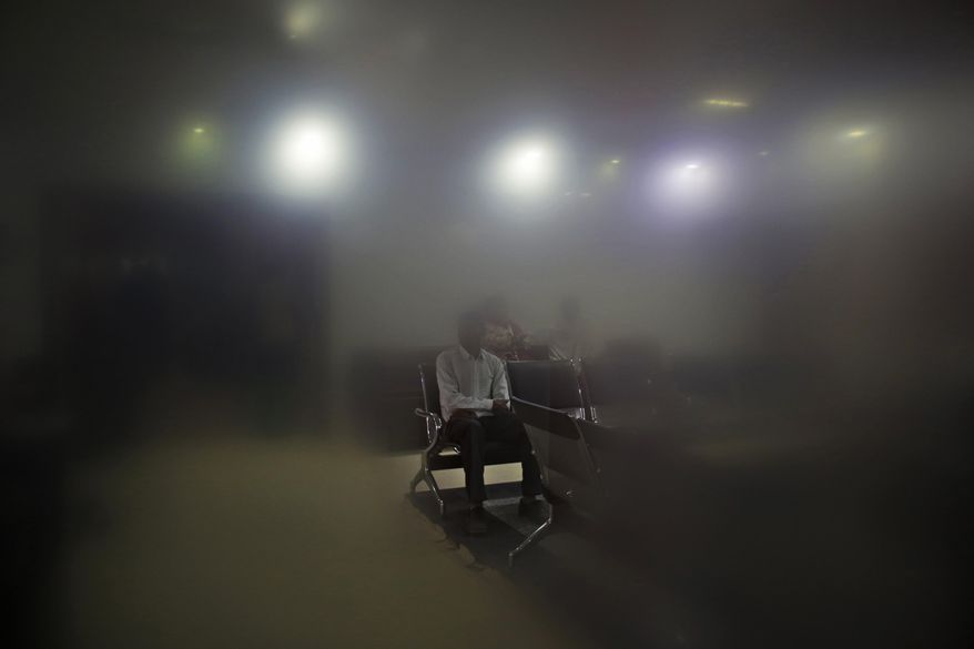 ADDS FIRST NAME OF DR. BISHNOI - In this Dec. 22, 2016 photo, Indian patients, seen from behind a fogged glass, wait for consultation inside the National Fertility and Test Tube Baby Centre in Hisar, India. The packed waiting room at Dr. Anurag Bishnoi’s clinic bears witness to the fact that working-class families across the country are willing to spend their limited savings for a child of their own. The cost of IVF treatment in India is relatively low, even though many families have to pay on their own. At Bishnoi&#39;s clinic, one cycle of IVF costs about 110,000 rupees ($1,700), compared to about $12,000 in the U.S. (AP Photo/Altaf Qadri)