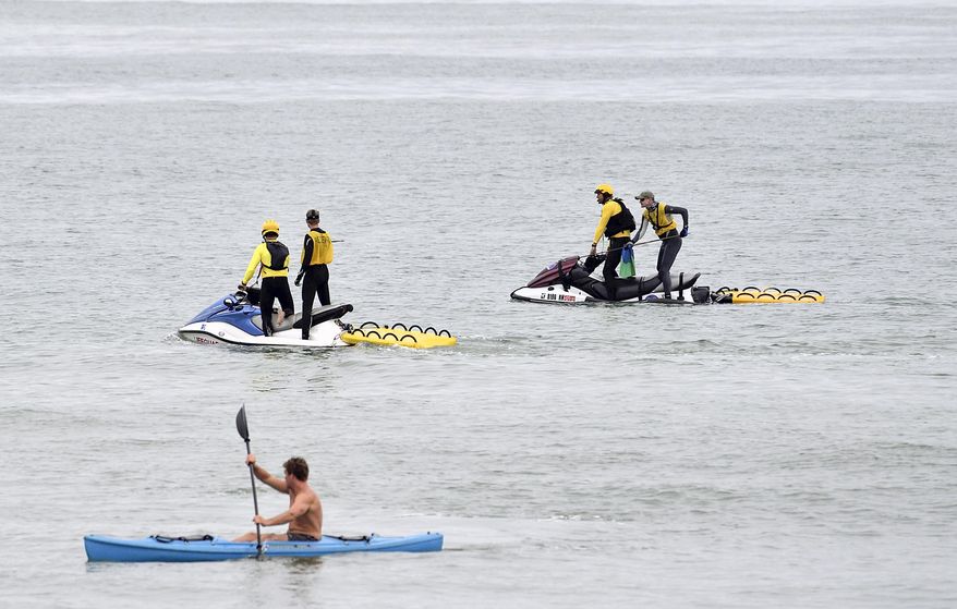 Lifeguards and researchers search for sharks to tag in the water off North Beach in San Clemente, Calif., on Wednesday, May 24, 2017. (Jeff Gritchen/The Orange County Register via AP)