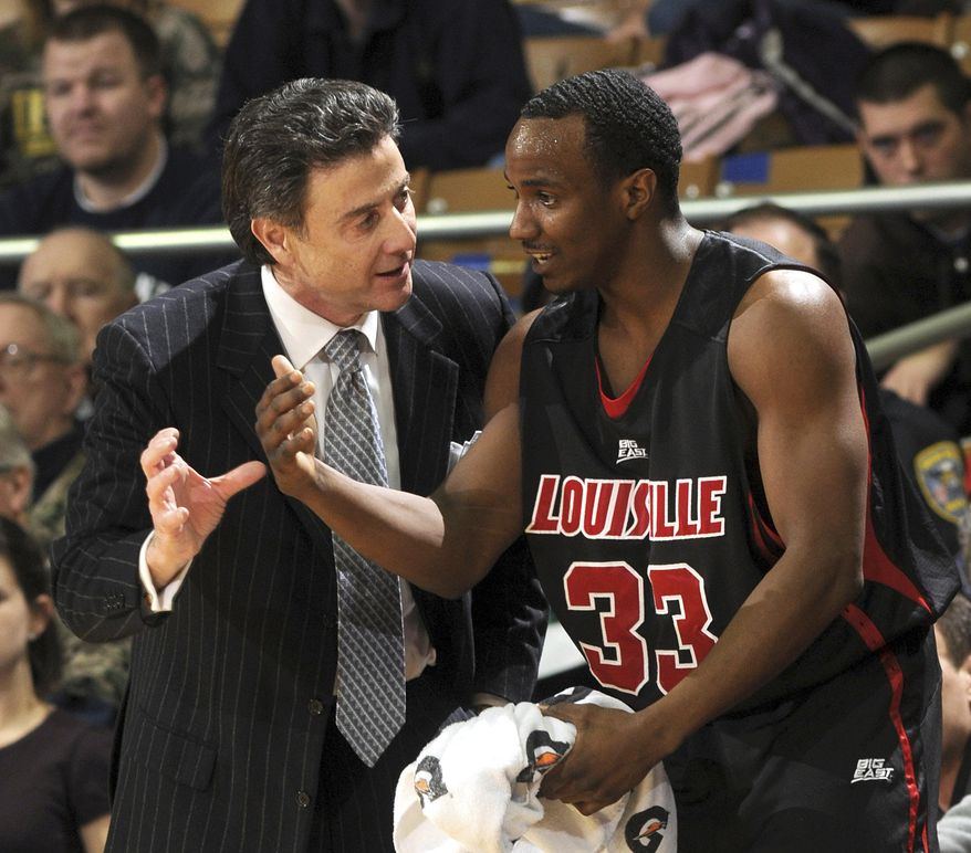 FILE - In this Feb. 12, 2009, file photo Louisville coach Rick Pitino, left, talks with guard Andre McGee during the first half of an NCAA college men's basketball game against Notre Dame in South Bend, Ind. A grand jury declined to indict an escort and former Louisville men's basketball staffer in a sex scandal that engulfed the program. The Jefferson County grand jury decided Thursday, May 25, 2017, there wasn't enough evidence for charges of prostitution and unlawful transactions with a minor against Katina Powell and Andre McGee. (AP Photo/Joe Raymond, File)