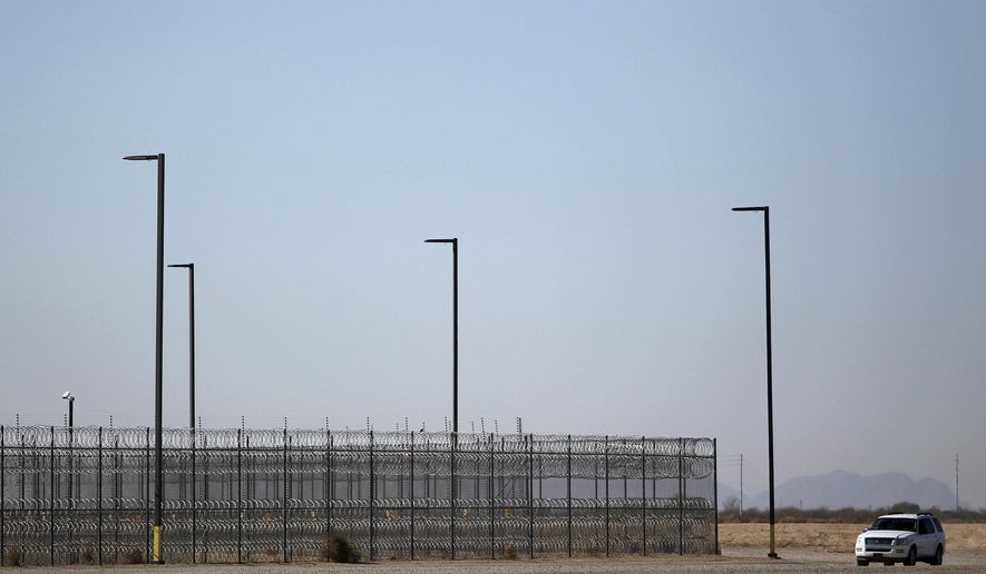 FILE - In this Jan. 20, 2016 file photo, an unmarked police truck patrols the outside of a private detention center operated by CoreCivic in Eloy, Ariz. The Mesa, Ariz., City Council has voted to make its city the first in Arizona to privatize its jail for low-level offenders. The council on Monday, May 22, 2017, approved a new three-year contract with CoreCivic, formerly known as Corrections Corp. of America, or CCA, for use of its facility in Florence, Ariz. (AP Photo/Ricardo Arduengo, File)