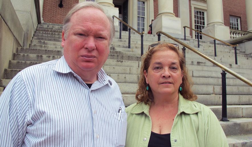 Matt and Cheryl Godbey, of Frederick, Maryland, stand in front of the Maryland State House on Thursday, May 25, 2017, in Annapolis after Gov. Larry Hogan signed a package of legislation aimed at battling heroin and opioid overdoses. Their daughter, Emily, died in November from a fentanyl overdose at the age of 24. "We just don't want other families to hurt like we are," Matt Godbey said. (AP Photo/Brian Witte)