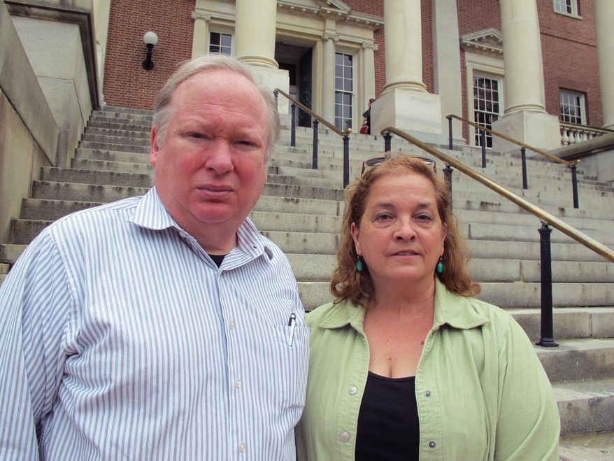 Matt and Cheryl Godbey, of Frederick, Maryland, stand in front of the Maryland State House on Thursday, May 25, 2017, in Annapolis after Gov. Larry Hogan signed a package of legislation aimed at battling heroin and opioid overdoses. Their daughter, Emily, died in November from a fentanyl overdose at the age of 24. "We just don't want other families to hurt like we are," Matt Godbey said. (AP Photo/Brian Witte)