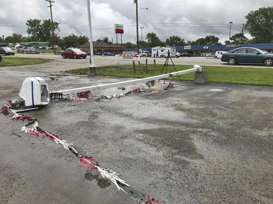 This May 25, 2017, photo provided by WHIO-TV shows a light pole that collapsed onto the parking lot of the Motor Sports of Dayton motorcycle dealership in New Carlisle, Ohio. Following severe overnight storms in western Ohio, suspected tornado damage was reported Thursday, May 25, 2017, in Clark, Greene and Miami counties north and east of Dayton, Ohio. (McCall Vrydaghs/WHIO-TV via AP)