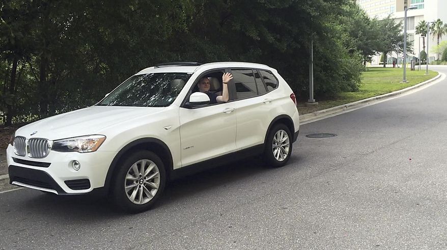 In this Friday, May 12, 2017, photo, journalist Scott Mayerowitz drives a white BMW X3 SUV, which was an upgraded rental car in Orlando, Fla., thanks to elite status in the National Car Rental program. Members of car rental loyalty programs, even those without status, get to skip the lines at the rental counter. (AP Photo/Scott Mayerowitz)
