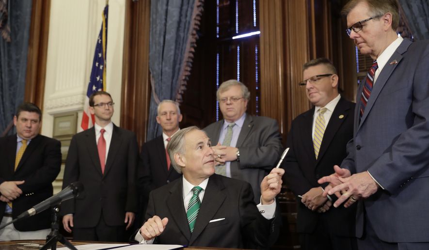 Gov. Greg Abbott, center, offers a pen to Lt. Gov. Dan Patrick, right, after he signed SB7, a bill to address inappropriate teacher-student relationships, after he signed it during a ceremony at the Texas Capitol in Austin, Thursday, May 25, 2017, in Austin. Standing behind Abbott, from left, Marc Salvato, Texas Education Commissioner Mike Morath, Rep. Gary VanDeaver, Sen. Paul Bettencourt and Rep. Tony Dale. (AP Photo/Eric Gay)