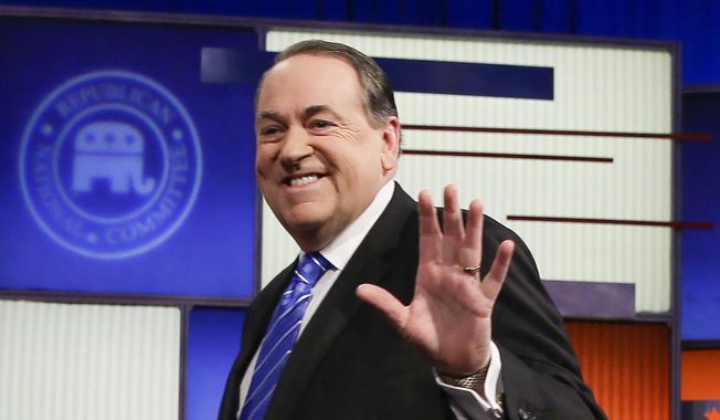 In this Jan. 28, 2016, file photo, former Arkansas Gov. Mike Huckabee walks onto the stage before a Republican presidential primary debate in Des Moines, Iowa. (AP Photo/Charlie Neibergall, File)