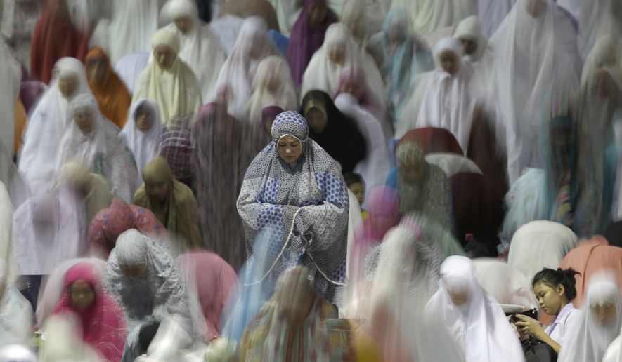 Muslim women perform an evening prayer called &#39;tarawih&#39; marking the first eve of the holy fasting month of Ramadan, at Istiqlal Mosque in Jakarta, Indonesia, Friday, May 26, 2017. During Ramadan, the holiest month in Islamic calendar, Muslims refrain from eating, drinking, smoking and sex from dawn to dusk. (AP Photo/Tatan Syuflana)