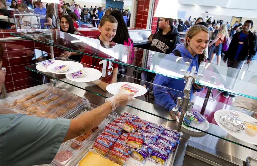 In a May 19, 2017 photo, Mount Jordan Middle School students get lunch in their school's cafeteria in Sandy, Utah. Canyons School District administrators are proposing that the school board adopt a policy that takes a kinder, gentler approach to school nutrition service to children whose accounts are in arrears. (Laura Seitz/The Deseret News via AP)/The Deseret News via AP)