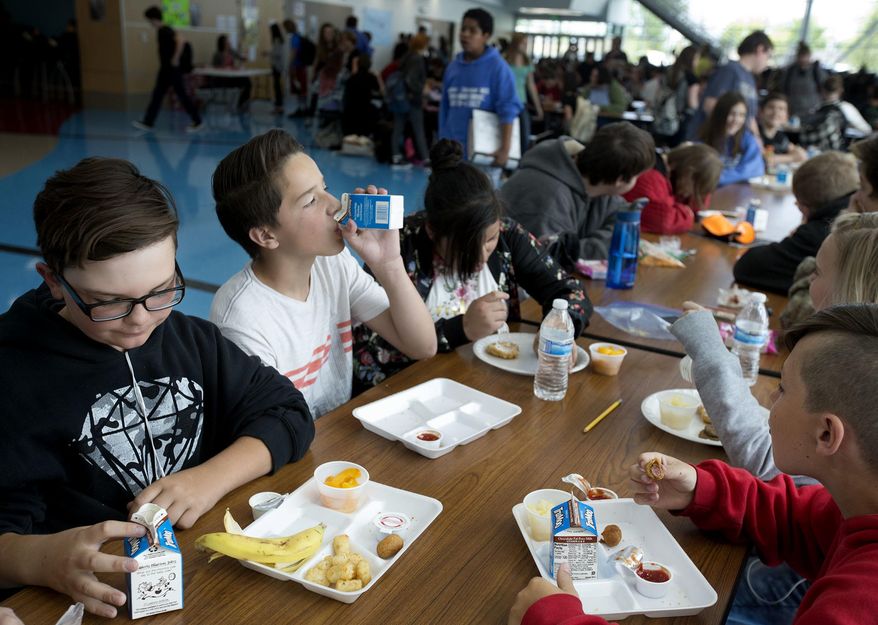 In a Friday, May 19, 2017 photo,Seventh-grader students eat lunch at Mount Jordan Middle School in Sandy, Utah. Canyons School District administrators are proposing that the school board adopt a policy that takes a kinder, gentler approach to school nutrition service to children whose accounts are in arrears. (Laura Seitz/The Deseret News via AP)