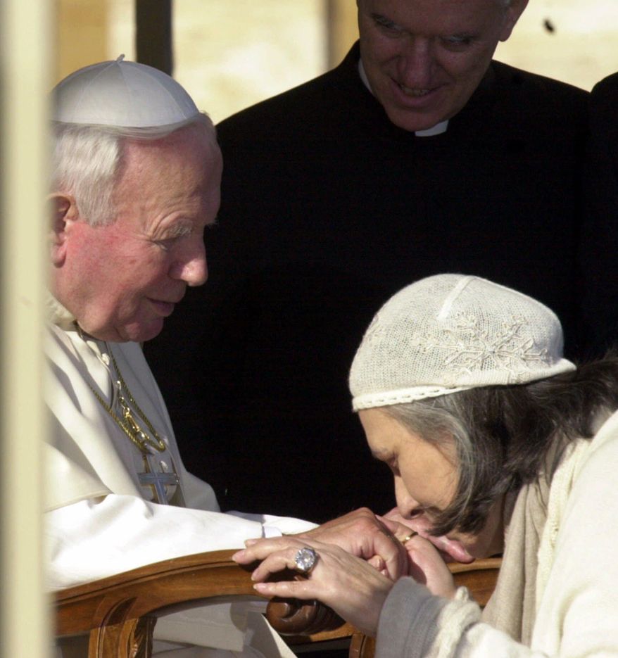 FILE - In this Dec. 16, 2000 file photo Italian fashion stylist Laura Biagiotti kisses Pope John Paul II's hand during a general audience at the Vatican. On Friday, May 26, 2017 Laura Biagiotti's daughter announced her mother's death after suffering a heart attack. She was 73. (AP Photo/Plinio Lepri, files)