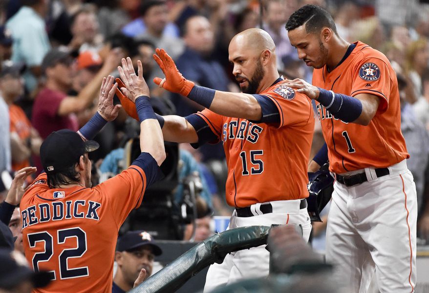 Houston Astros' Carlos Beltran (15) celebrates his solo home run off Baltimore Orioles starting pitcher Kevin Gausman with teammates Carlos Correa, right, and Josh Reddick (22) during the sixth inning of a baseball game, Friday, May 26, 2017, in Houston. (AP Photo/Eric Christian Smith)